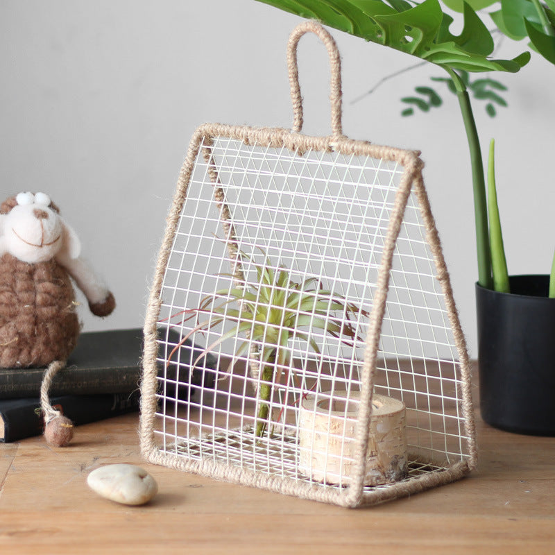 Decorative plant holder made of wire and natural fiber