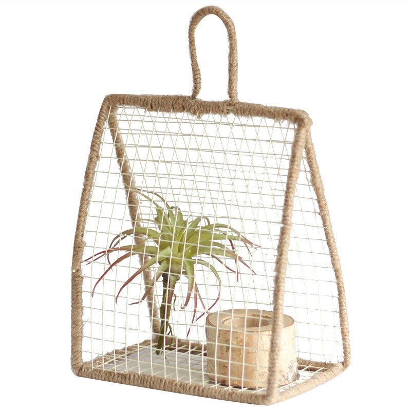 Decorative plant holder made of wire and natural fiber