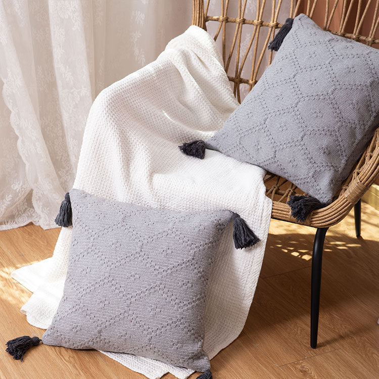 Square Boho cushion cover made of handwoven cotton with textured relief weaving and four tassels