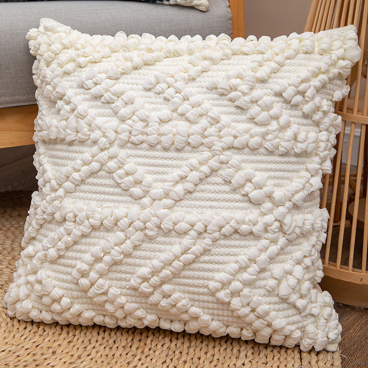 Square woven decorative cushion cover with crocheted appliqués and textured relief
