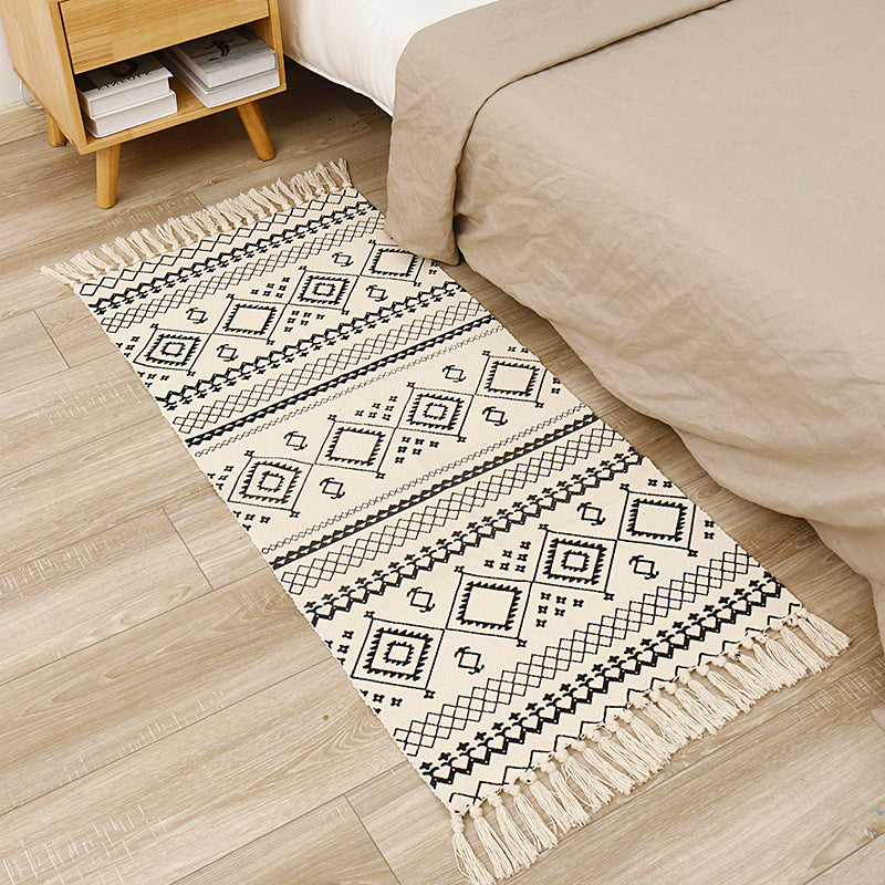 Flat-woven cotton runner with graphic stripe pattern and fringes