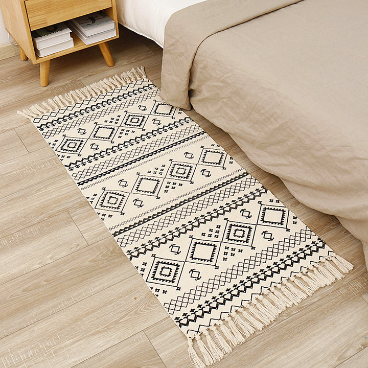 Flat-woven cotton runner with graphic stripe pattern and fringes