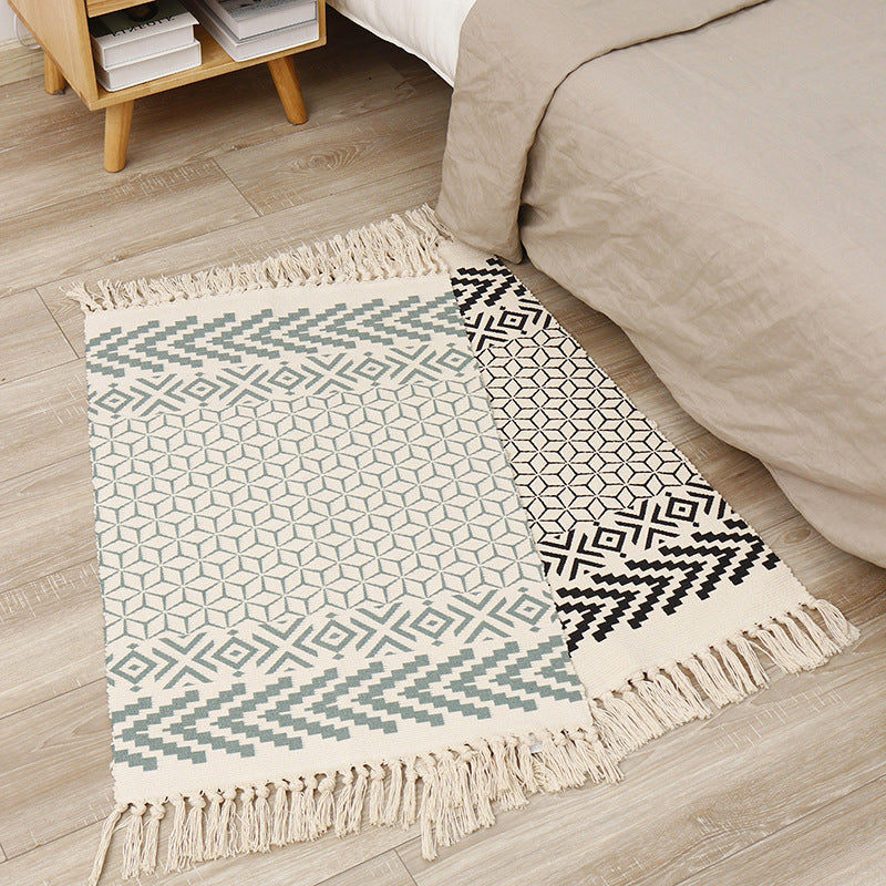Flat-woven cotton runner with graphic stripe pattern and fringes