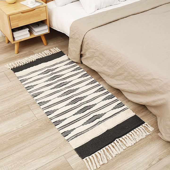 Flat-woven cotton runner with graphic stripe pattern and fringes