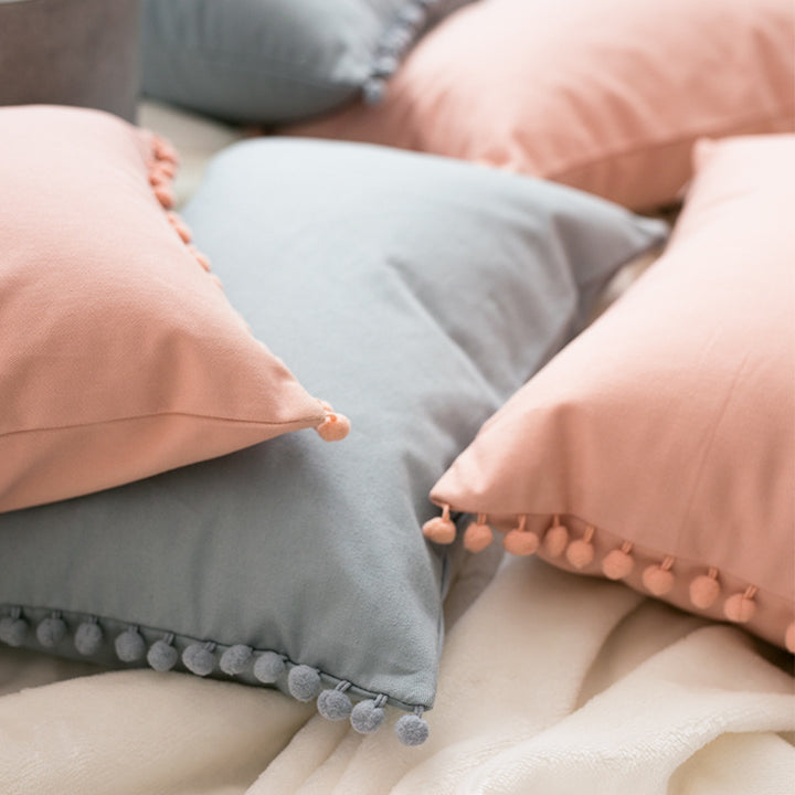Decorative cushion cover with pompom border made of cotton-linen blend