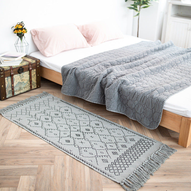 Woven cotton rug runner with flat weave structure, graphic diamond ethnic pattern and fringes