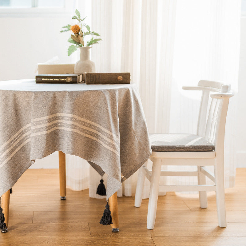Rectangular linen look tablecloth with fringed tassels and side stripe border design