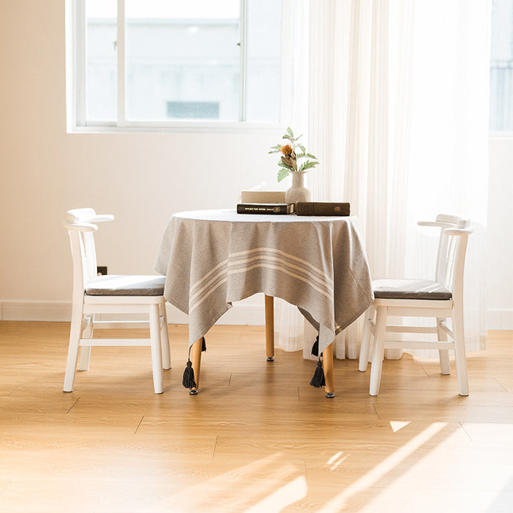 Rectangular linen look tablecloth with fringed tassels and side stripe border design