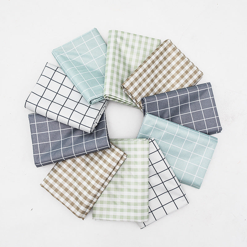 Wipeable tablecloth with fine check pattern, wavy hem and easy-care PVC finish