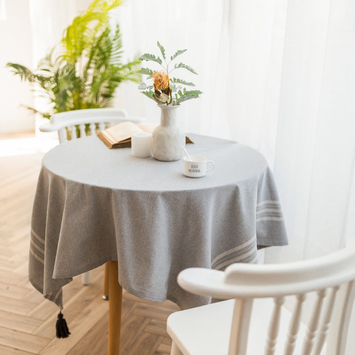 Rectangular linen look tablecloth with fringed tassels and side stripe border design