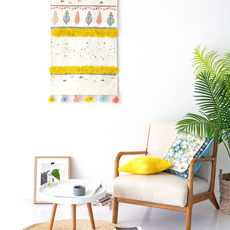 Wall tapestry in Scandi-Boho style with tufting stripes, tassels, and wooden rod