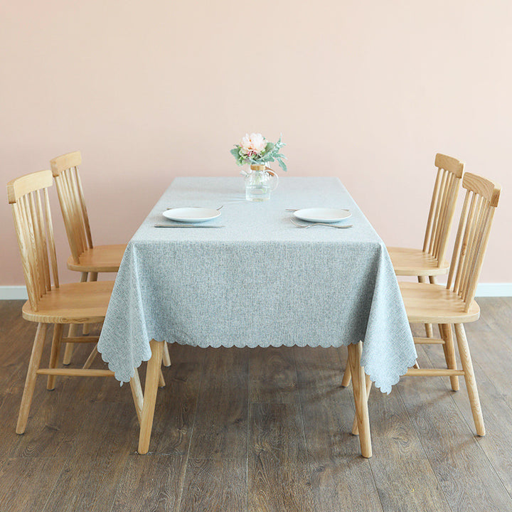 Tablecloth made of cotton blend with wavy hem and textured surface