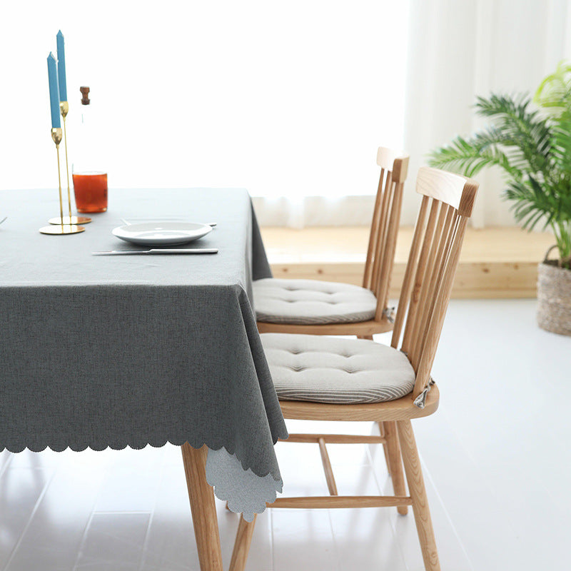 Tablecloth made of cotton blend with wavy hem and textured surface
