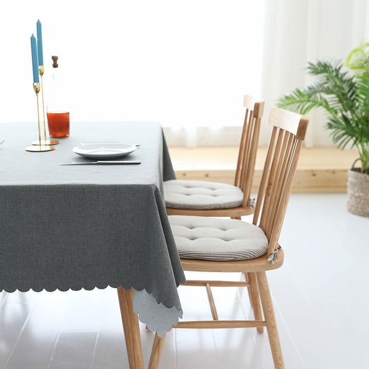 Tablecloth made of cotton blend with wavy hem and textured surface