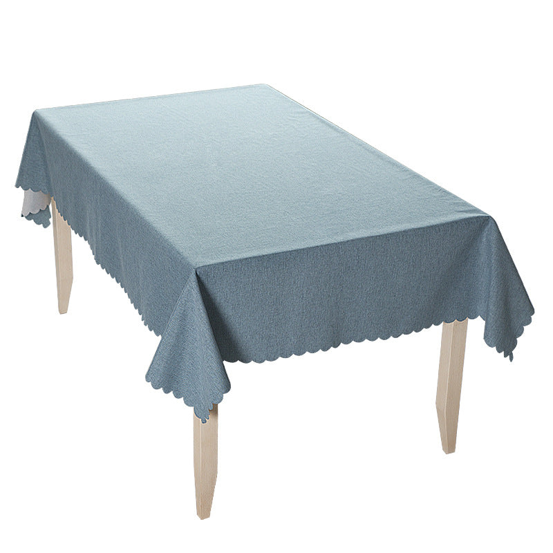 Tablecloth made of cotton blend with wavy hem and textured surface