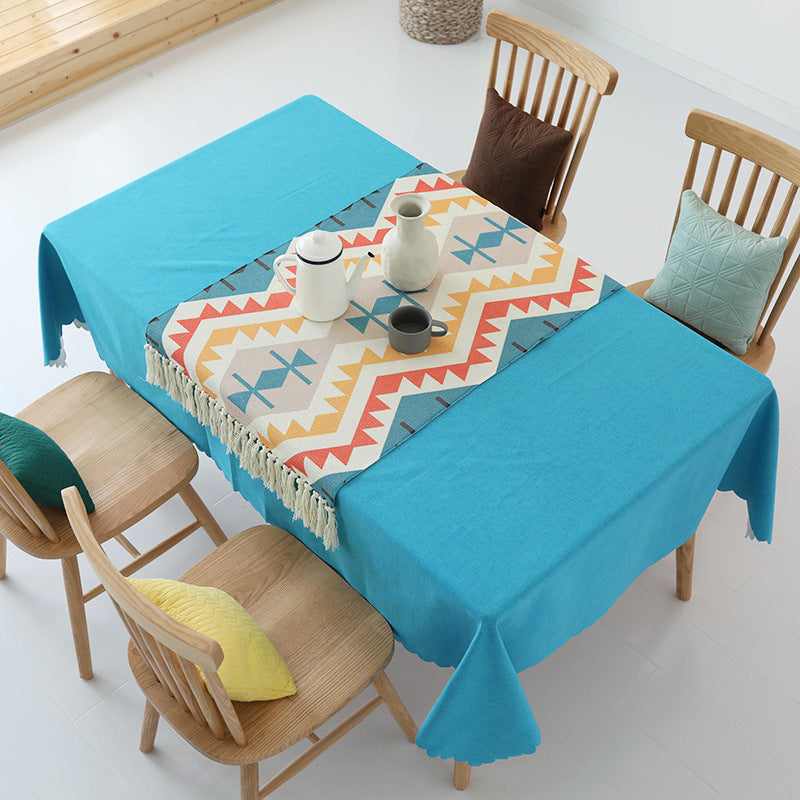 Tablecloth made of cotton blend with wavy hem and textured surface