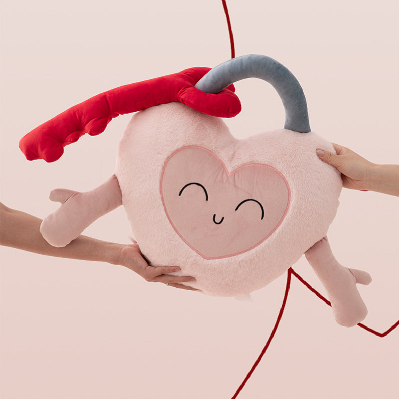 Heart-shaped cuddle castle cushion with attached key and friendly face