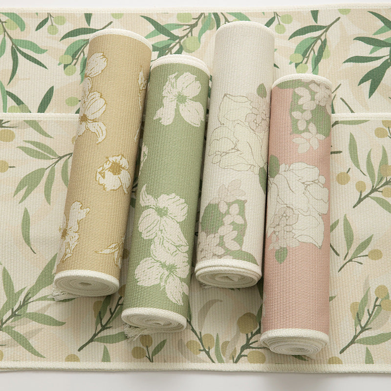 Woven botanical table runner with olive branch motif and fringed edge