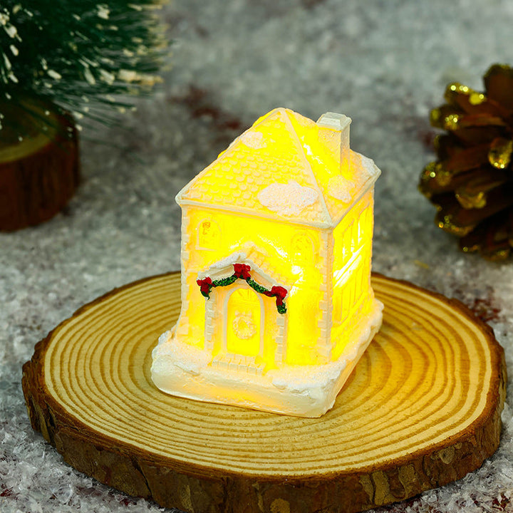 Illuminated Christmas village house with festive decoration