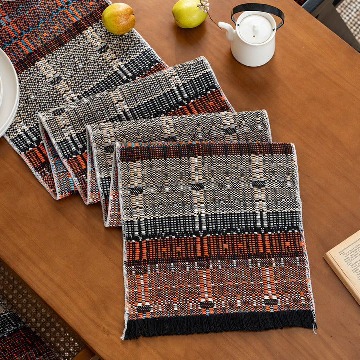 Woven table runner in ethnic look made of cotton blend with fringes