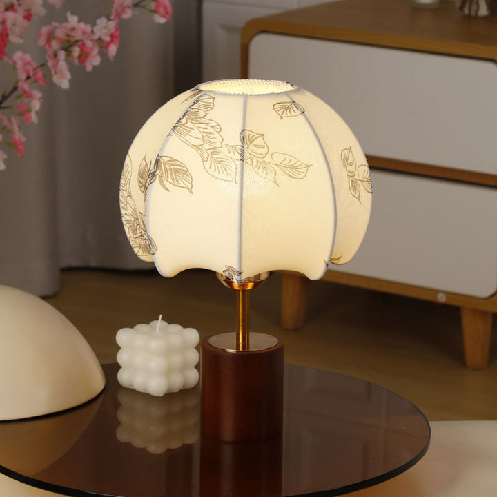Sculptural table lamp with wooden base, brass stem, and cardboard shade