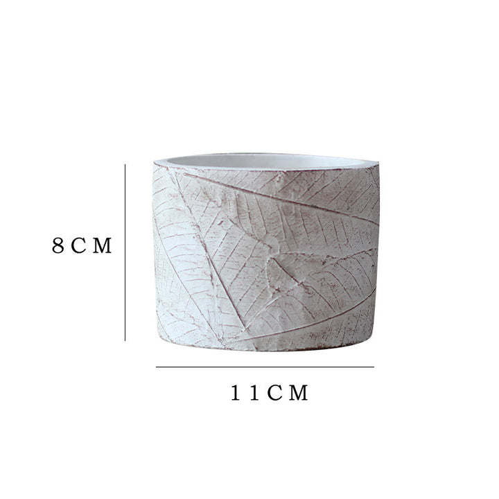 Decorative plant container made of handmade ceramic with leaf pattern