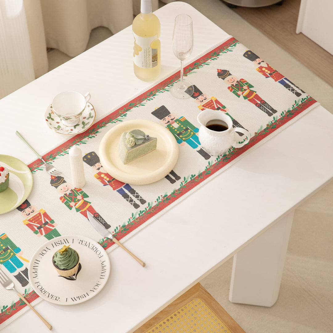 Festive woven table runner with nutcracker motif and golden fringes