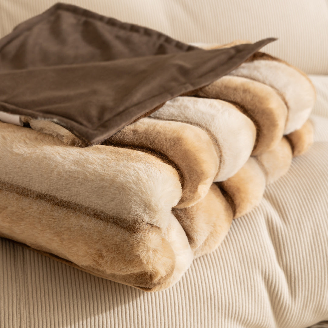 Luxurious faux fur throw blanket with relief-style quilting