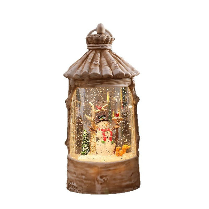 Illuminated Christmas lantern with snow scenes