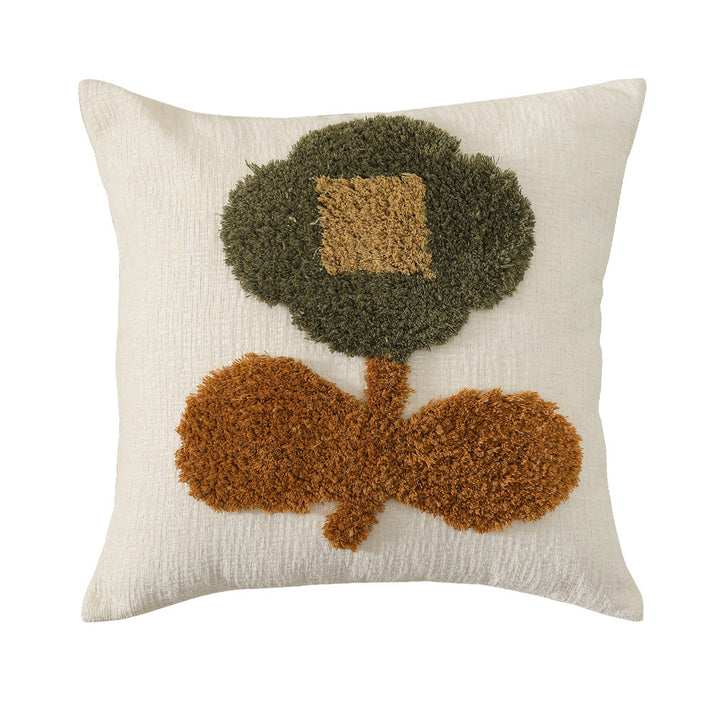 Square decorative pillow with hand-tufted floral appliqué and textured linen look