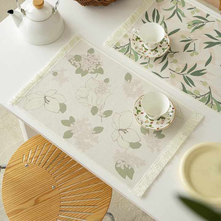 Floral woven bath mat with decorative fringes
