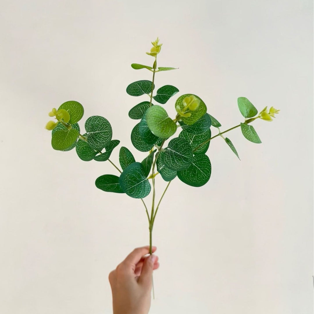 Artificial flowering branch with lifelike leaves and delicate flowers
