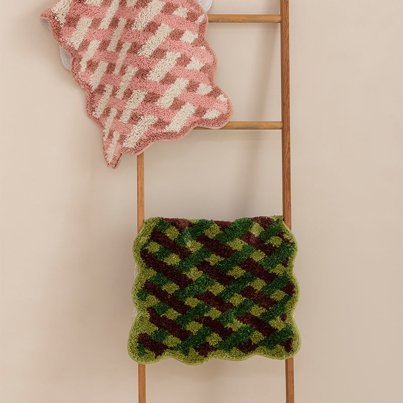 Tufted bathroom runner with wavy hem and relief-style braided pattern