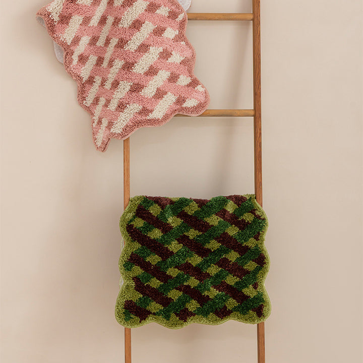 Tufted bathroom runner with wavy hem and relief-style braided pattern