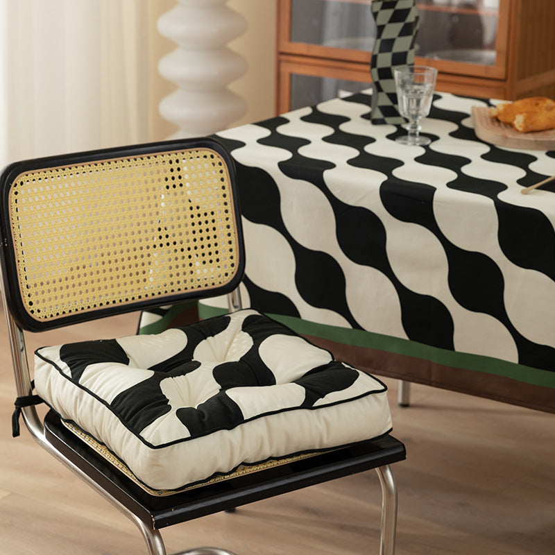 Padded chair cushion with ties and tufted seat