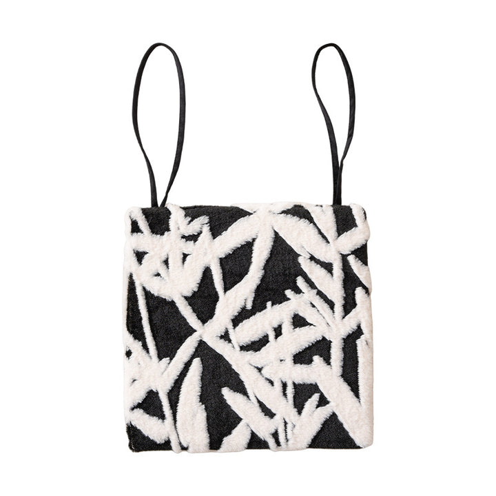 Padded seat cushion with hand-tufted leaf pattern and fastening ties