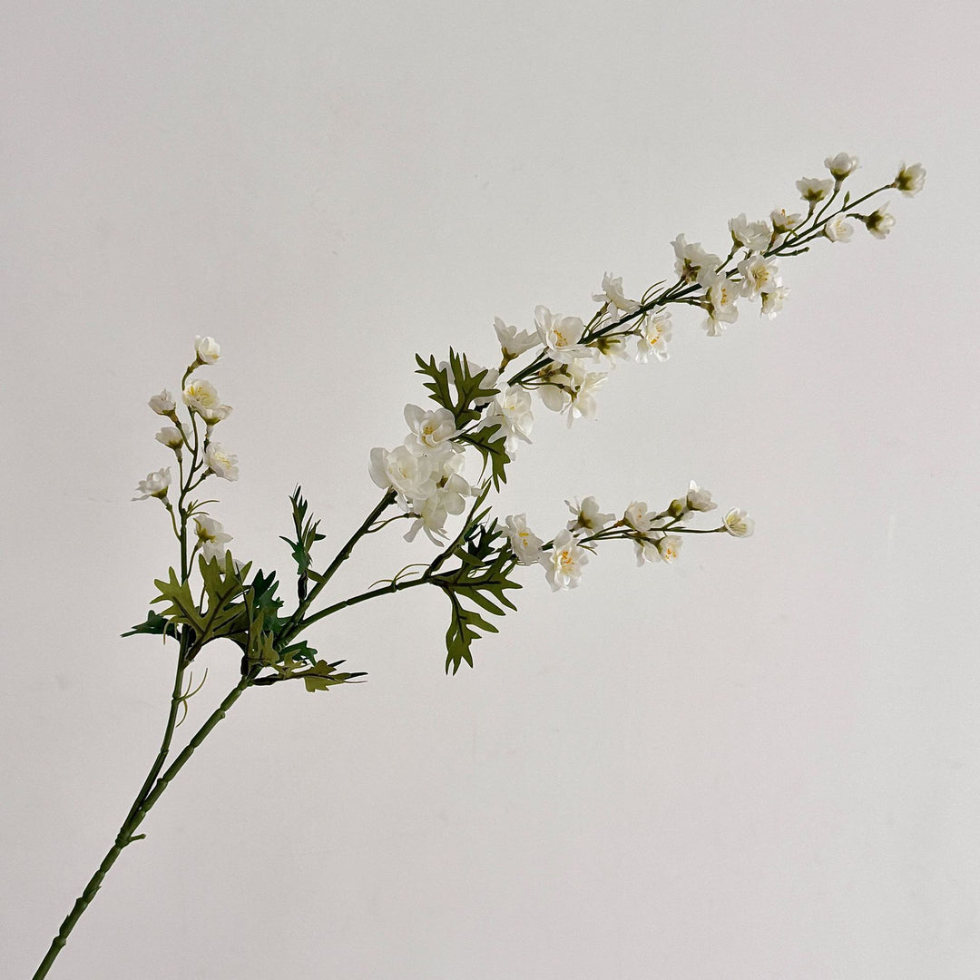Artificial flower branch with intricately detailed red flowers