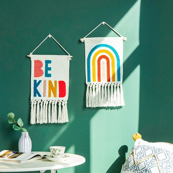 Boho wall hanging made of woven cotton with hand-tufted appliqués and fringes