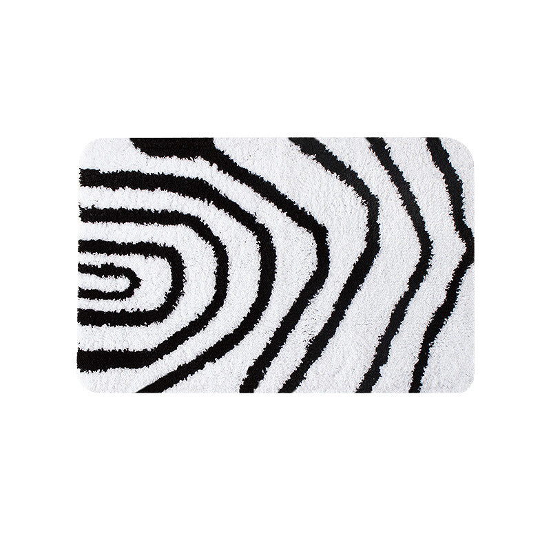 Fluffy bath mat in a graphic wave relief with anti-slip base