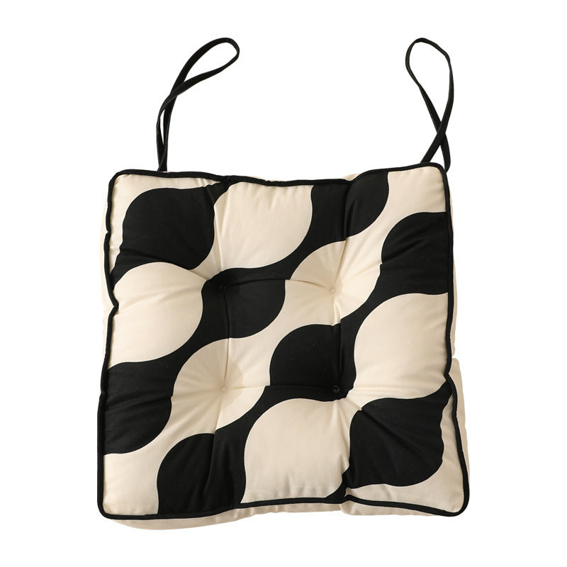 Padded chair cushion with ties and tufted seat