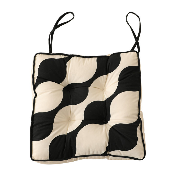 Padded chair cushion with ties and tufted seat