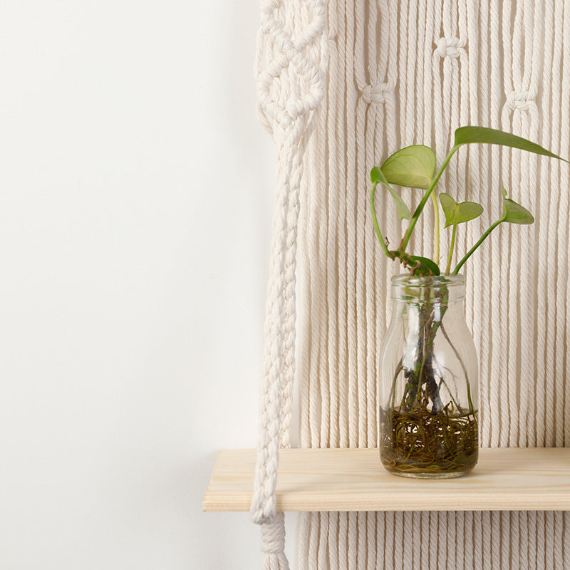 Macramé wall shelf with integrated plant holder