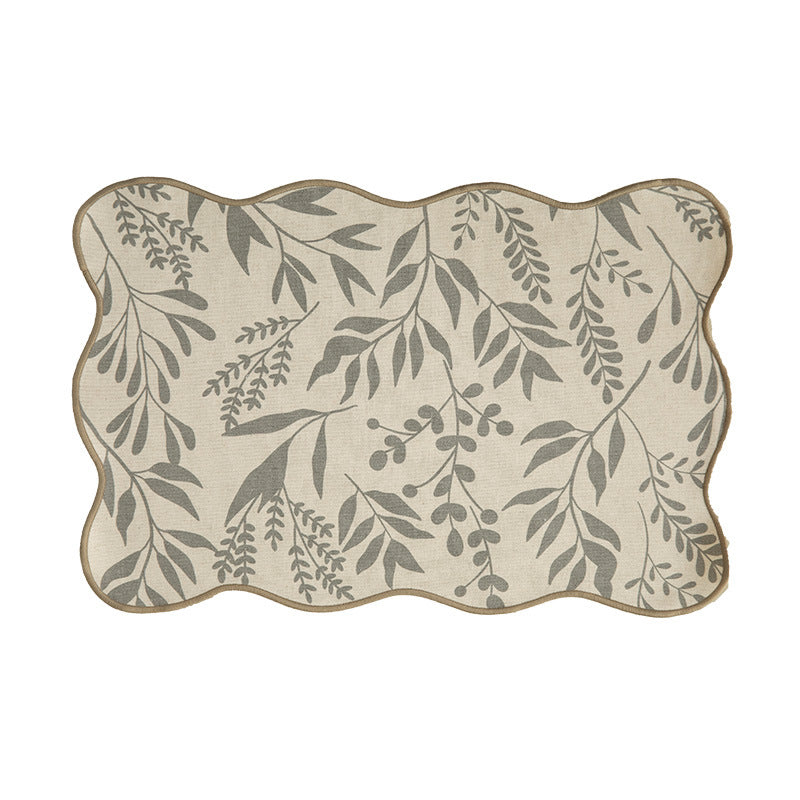 Shaped placemat made of cotton-linen with wavy edge and leaf pattern