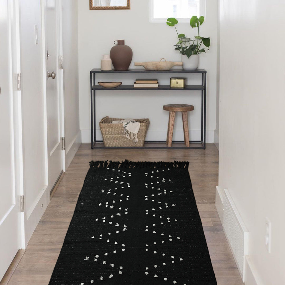 handwoven living room rug with fringes and geometric perforated pattern