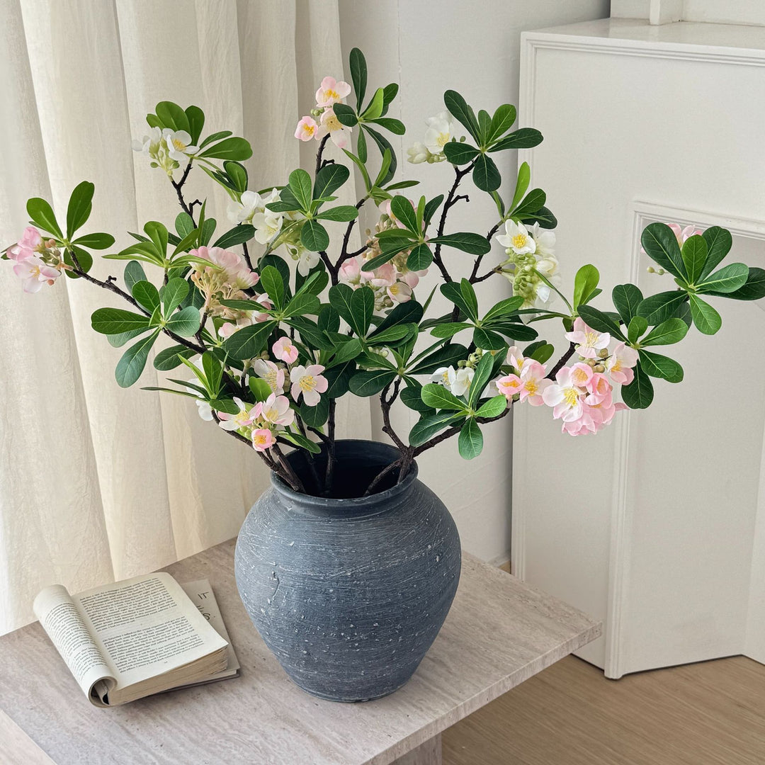 Artificial flower branch with fine pink flowers and vibrant leaves