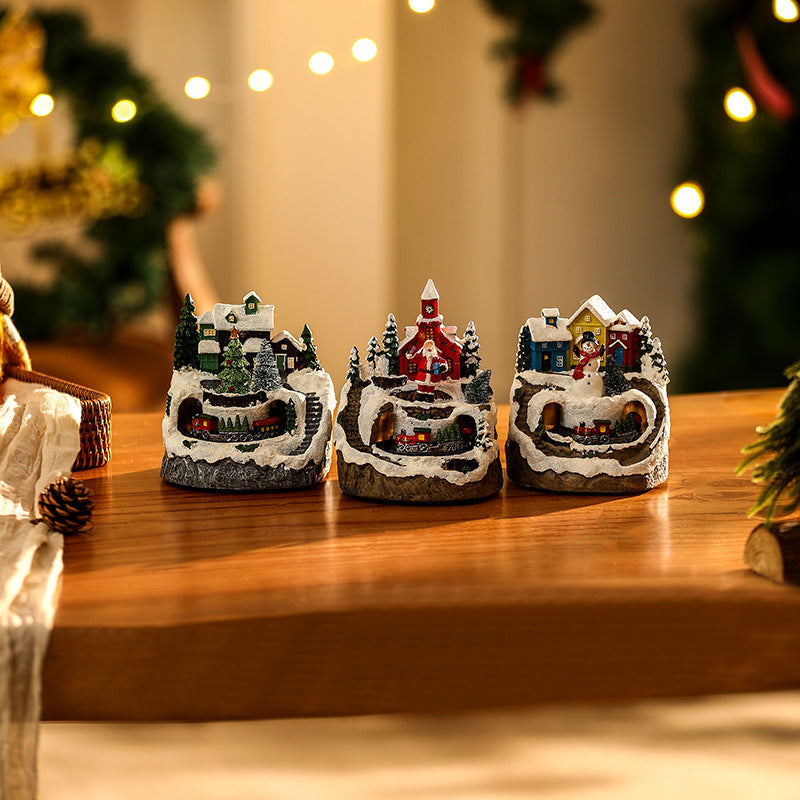 Illuminated Christmas village scene with snowman