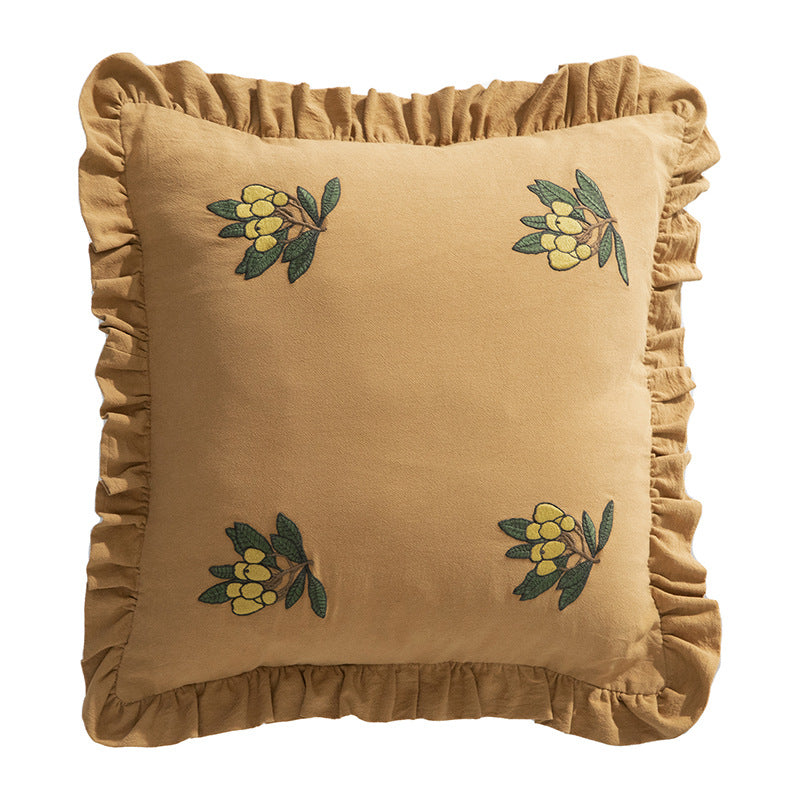 Square decorative pillow with ruffled edges and hand-stitched flower appliqués