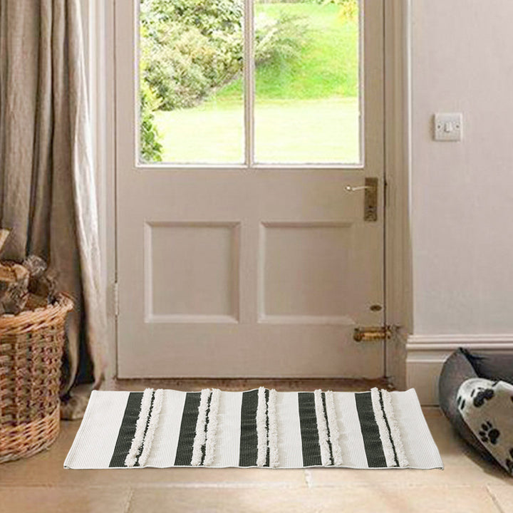 Cotton bath mat with textured stripes and fringes