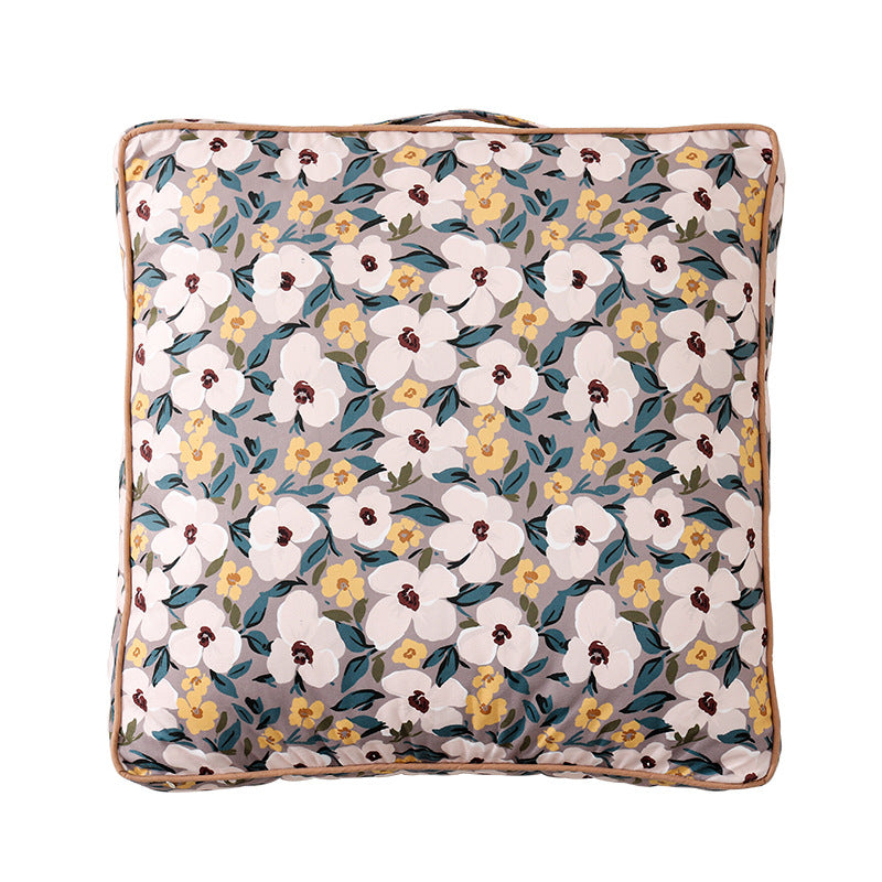 Large square floor cushion with floral cotton cover, piping, and carrying handle