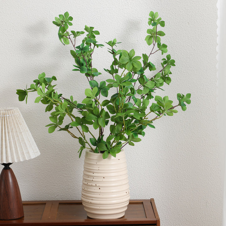 Decorative artificial branch with vibrant leaves